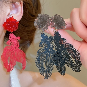 Detail of resin flower and hollow koi fish drop earrings in red and black colors