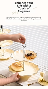 Detail of cream ceramic 2-tier dessert stand with scalloped edges and silver metal handle