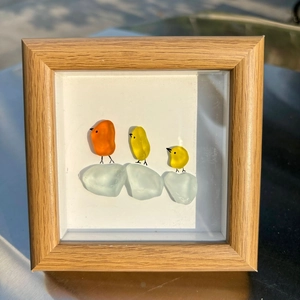 Art en verre de mer encadré représentant trois oiseaux colorés sur une branche
