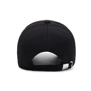 Back view of a minimalist black cotton baseball cap with adjustable silver metal buckle.