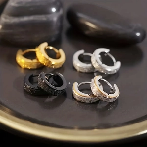 Set of four stainless steel huggie earrings in gold, silver, and black with frosted finish