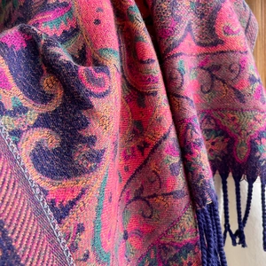 Ethnic paisley shawl with fringe detail in pink and purple, perfect for travel vacations
