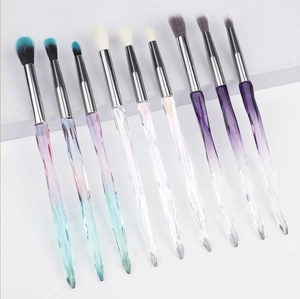 Detail of 9-piece makeup brush set with crystal acrylic handles on white background