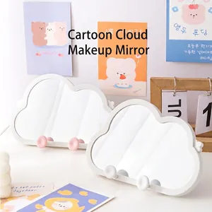 Irregular cloud-shaped vanity mirror with white frame and minimalist desktop stand