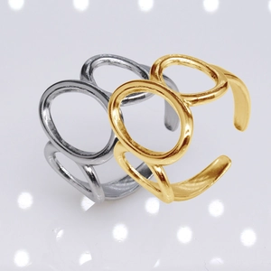 Detail view of gold and silver open rings with hollow oval links and polished finish