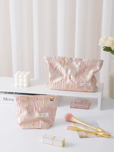 Floral jacquard makeup bag set in pink satin with elegant golden flower patterns