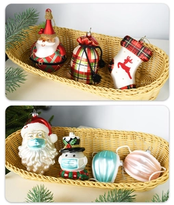 Hand-painted glass Christmas ornaments featuring Santa Claus and snowman with face masks
