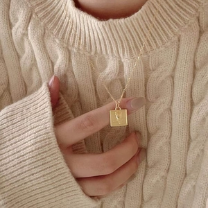 925 sterling silver square rose necklace in gold, styled on a warm knit sweater
