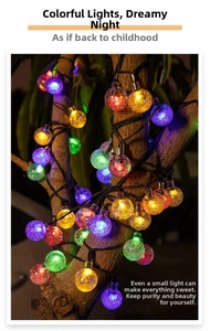 Solar multi-color bubble LED string lights wrapped on a tree for garden decoration