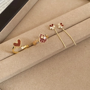 Detail of luxury 18k gold plated heart ring and wine red enamel jewelry set on display