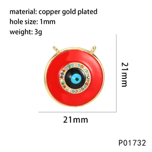 Macro detail of red Evil Eye circular pendant with gold-plated copper and cubic zirconia