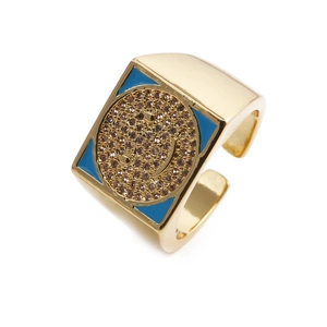 Golden wide band ring with blue enamel and pavé zircon smiley face on white background