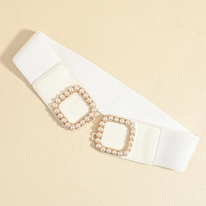 Close-up of white elastic waist belt featuring gold interlocking buckles with pearls