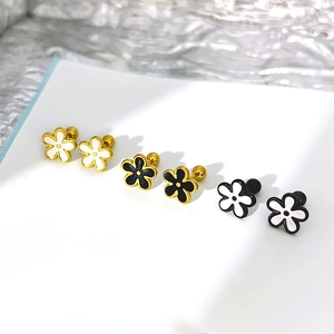 Three pairs of elegant enamel daisy stud earrings in gold, black and white floral designs