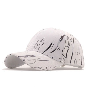 White baseball cap with black marble pattern and curved brim in a 45-degree side view