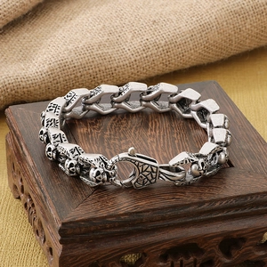 Close-up of vintage titanium steel skull bracelet with gothic engraving and heavy texture