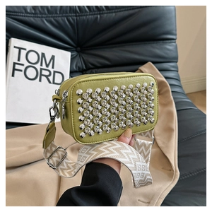 Close-up of olive green leather crossbody bag featuring rows of sparkling rhinestones