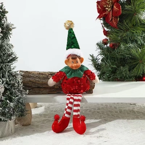 Close-up of a Christmas elf doll in red and green sequins sitting on a bench