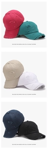 Detail view of washed cotton baseball caps showing distressed holes in six various colors