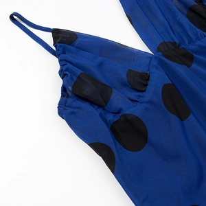 Detail of blue chiffon dress with black polka dots featuring delicate spaghetti straps
