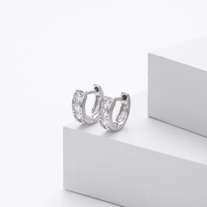 Macro shot of silver hoops with pave-set white cubic zirconia on geometric steps