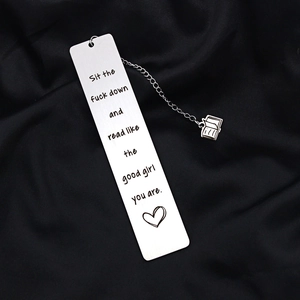 Stainless steel bookmark with book charm and funny quote on black fabric background