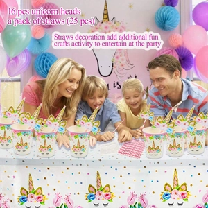 Close-up of rainbow unicorn party straws and decorations with gold glitter details
