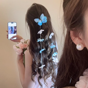 Detail view of light blue fabric butterfly hair clip with elegant pearl flower tassels