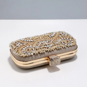 Detailed close-up of champagne gold evening bag with rhinestone-encrusted floral pattern