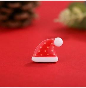 Detailed view of red Christmas hat resin flatback with star pattern for DIY crafts