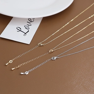 Detail of adjustable gold and silver plated O-chains with lobster clasps on leather