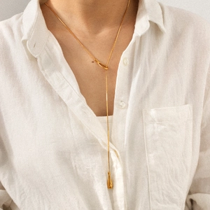 Detailed view of long 18k gold plated stainless steel necklace with teardrop pendant