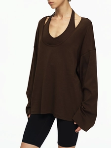 Detail view of dark brown loose long-sleeved top with matching halter inner layer