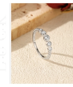 Macro shot of S925 sterling silver bubble ring with five stones and stone background