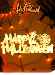 Detail of Happy Halloween LED sign with warm glowing pumpkin and cat elements