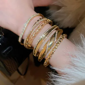 Elegant 18k gold plated bangle set with cubic zirconia worn by model with fur texture