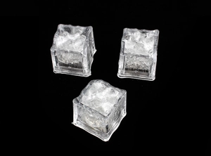 Detailed view of three square LED ice cubes with internal frozen gel texture on black background