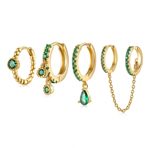 Golden earrings set with emerald green zircon chain tassels and polished ear cuffs