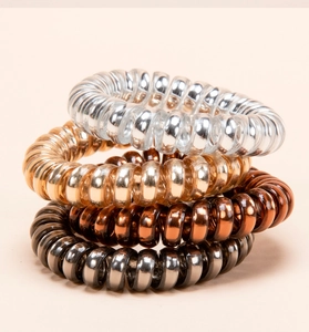 Set of four metallic spiral hair ties in silver, gold, bronze, and grey with TPU texture