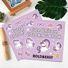 Overhead view of cute unicorn coloring books stacked with natural decor and bright lighting