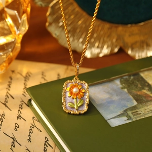 Detail of sunflower pendant with pearl on purple enamel and vintage necklace style