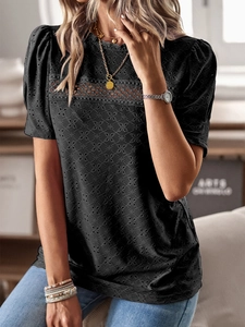 Close-up of black hollow textured fabric and bubble sleeves on a round neck casual T-shirt