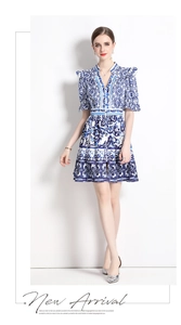 Detail of V-neck porcelain print dress showing blue and white Mediterranean tile patterns
