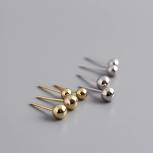 Macro shot of 5mm gold and silver polished s925 sterling silver bead stud earrings set