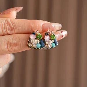 Vintage geometric triangle earrings with colorful gems and beads in a retro court style