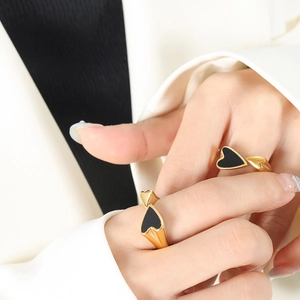 18K gold plated ring with double heart design and black enamel inlay worn by a model