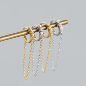 Close-up of S925 silver hoop earrings with zircon stones and long hanging tassels