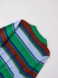 Detailed view of the striped knit polo sweater collar showing green and blue horizontal lines