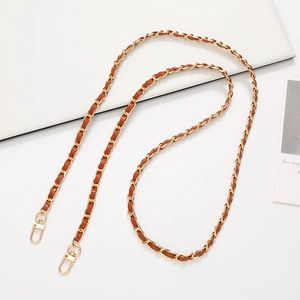 Detail view of brown leather woven with gold metal chain strap and lobster clasps