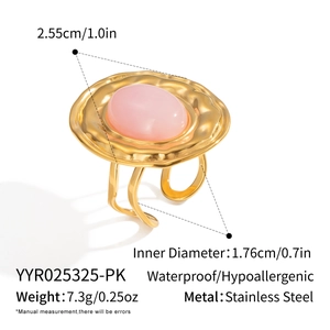 Macro detail of gold plated stainless steel ring with pink gemstone and sizing labels